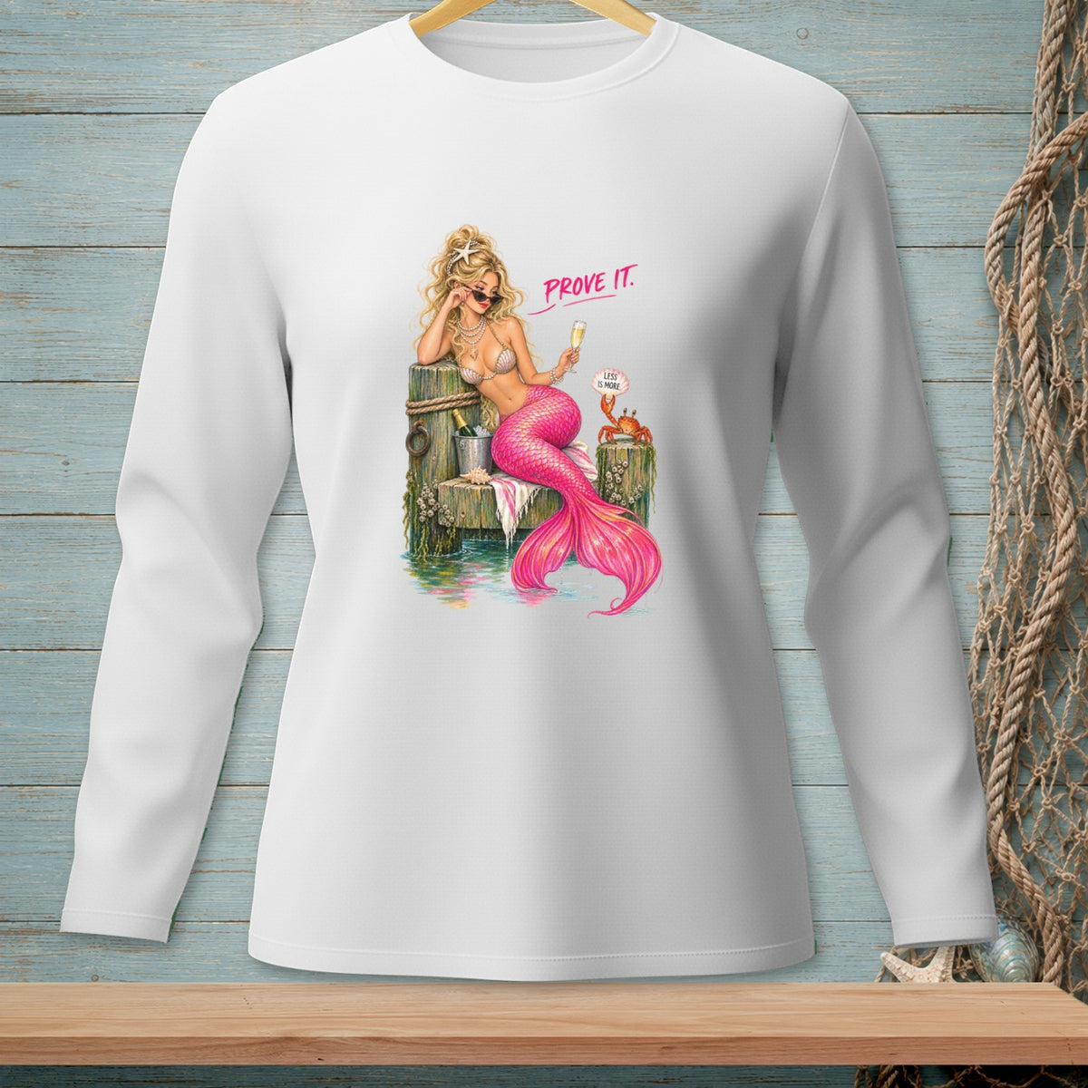 Mermaid on dock with champagne, crab, and text "PROVE IT. LESS IS MORE."