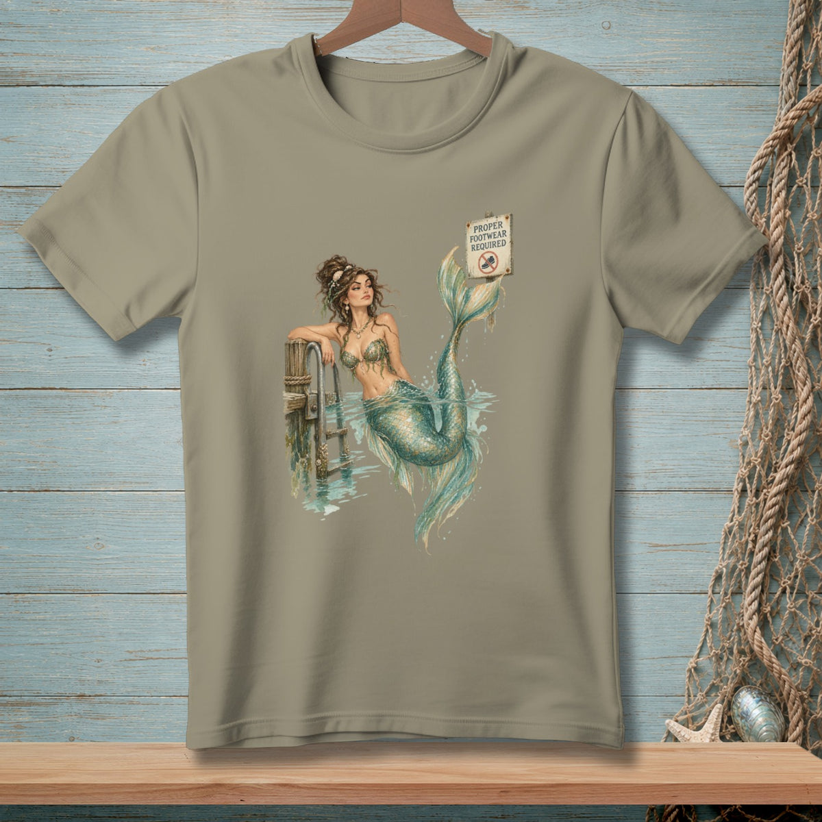 Mermaid leaning on dock with "Proper Footwear Required" sign.