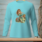 Turquoise long-sleeve shirt with a graphic of a mermaid sitting on a rock next to a picnic basket and a crab.