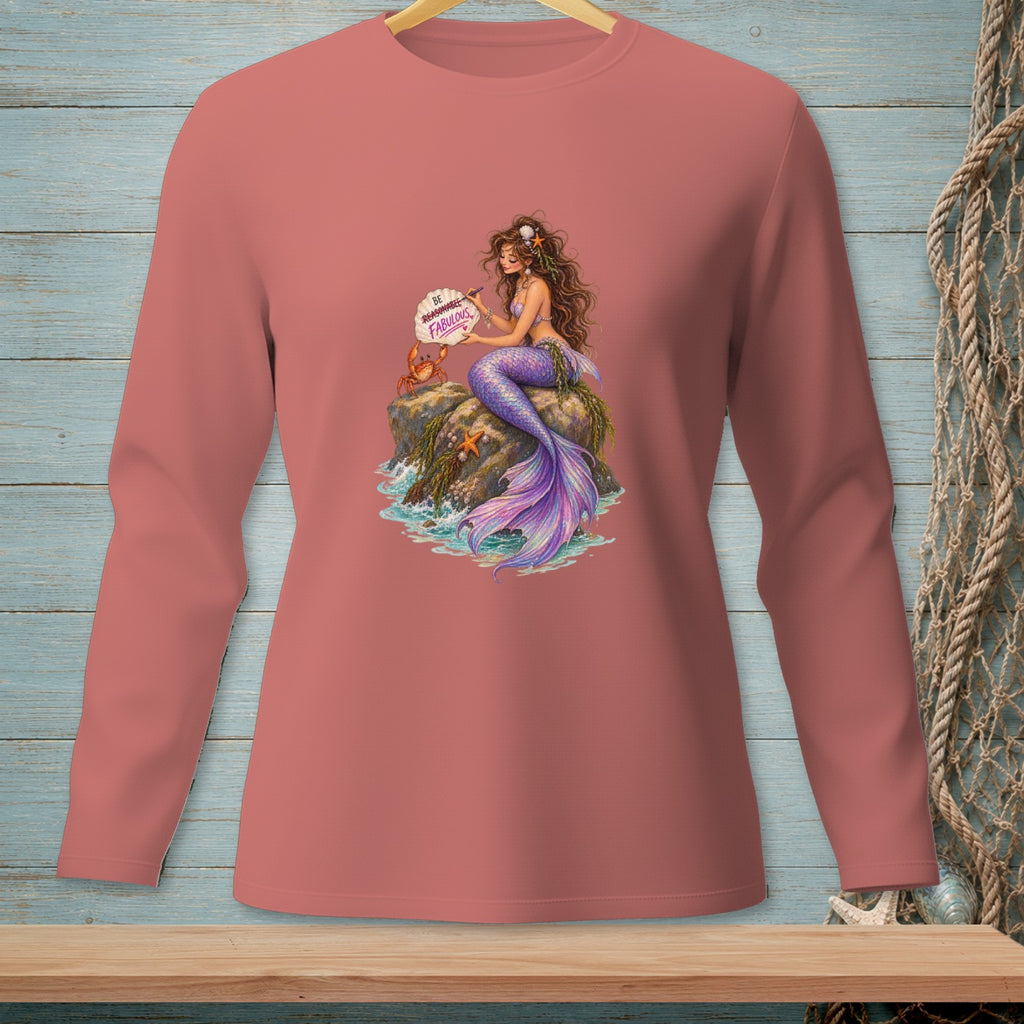 Mermaid sitting on rocks with crab and starfish, holding a sign reading "Be Reasonable. Be Fabulous."