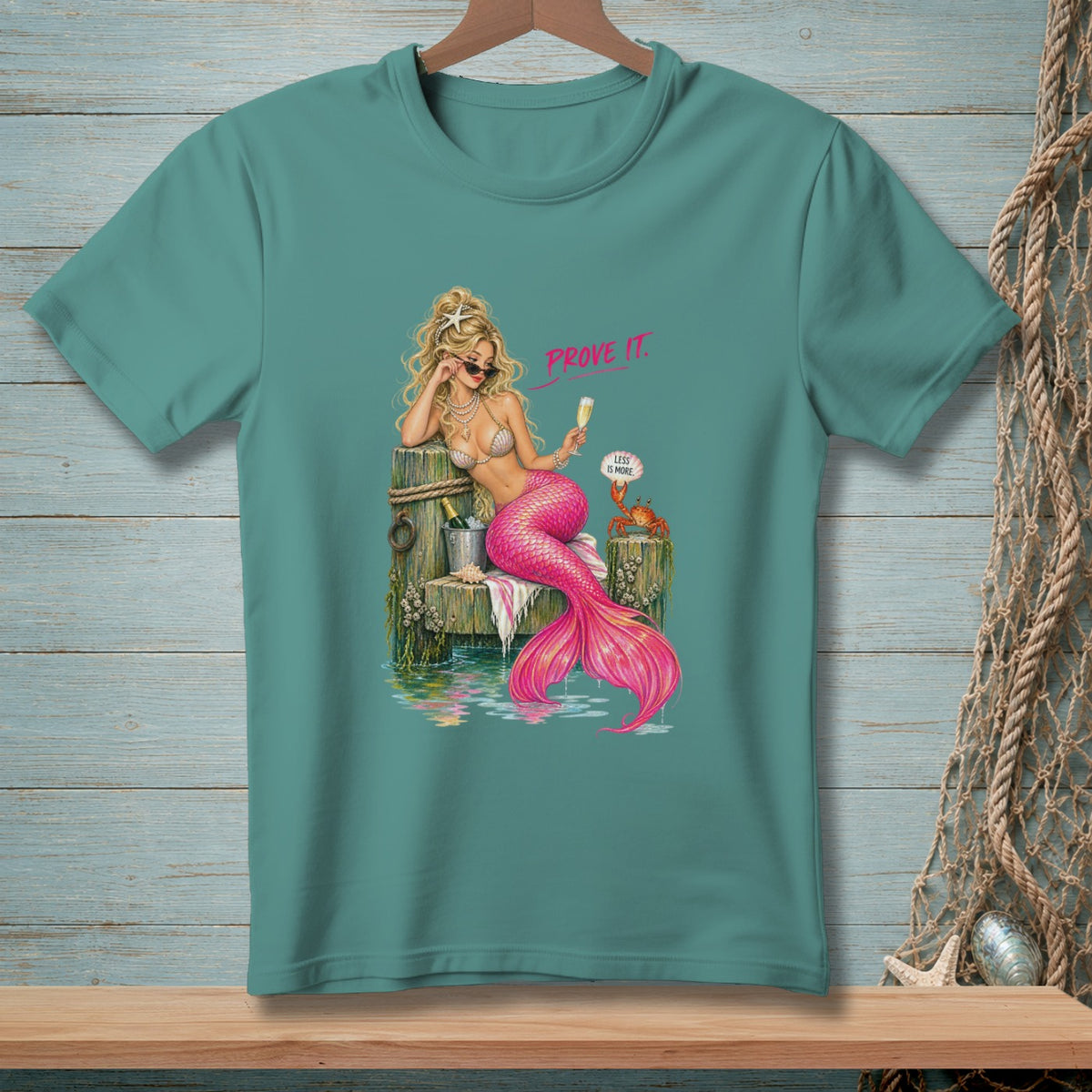 Mermaid with pink tail, sunglasses, champagne, and crab reads "Prove it. Less is more."