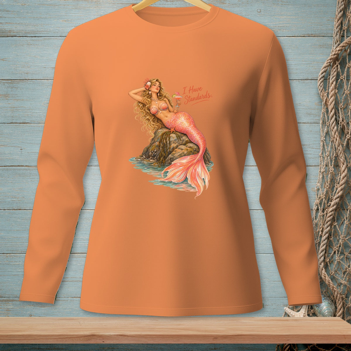 Long sleeve orange shirt with a vintage mermaid graphic and text.