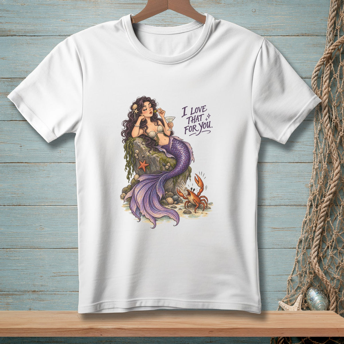 Illustration of a mermaid on a rock with text "I LOVE THAT FOR YOU."