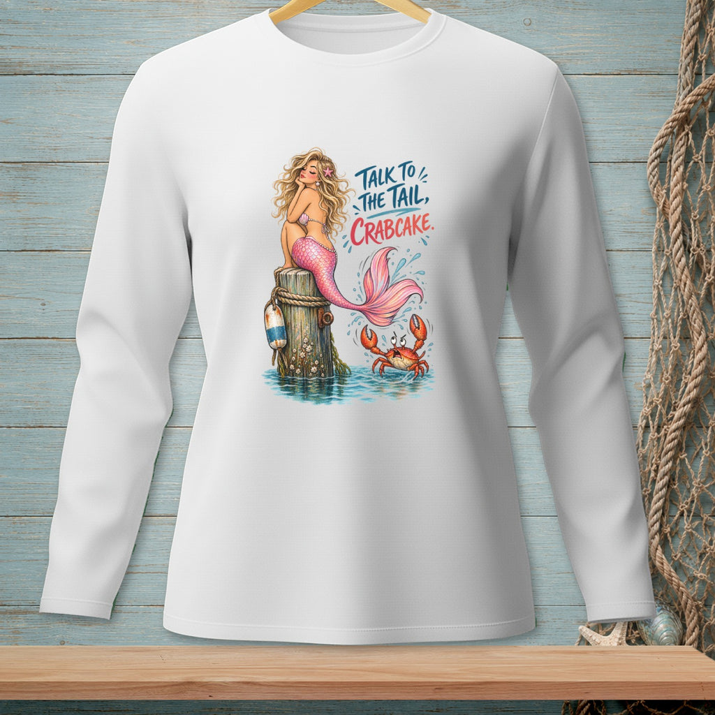White long-sleeve shirt with a mermaid sitting on a post with a crab and text "Talk to the tail, crabcake."