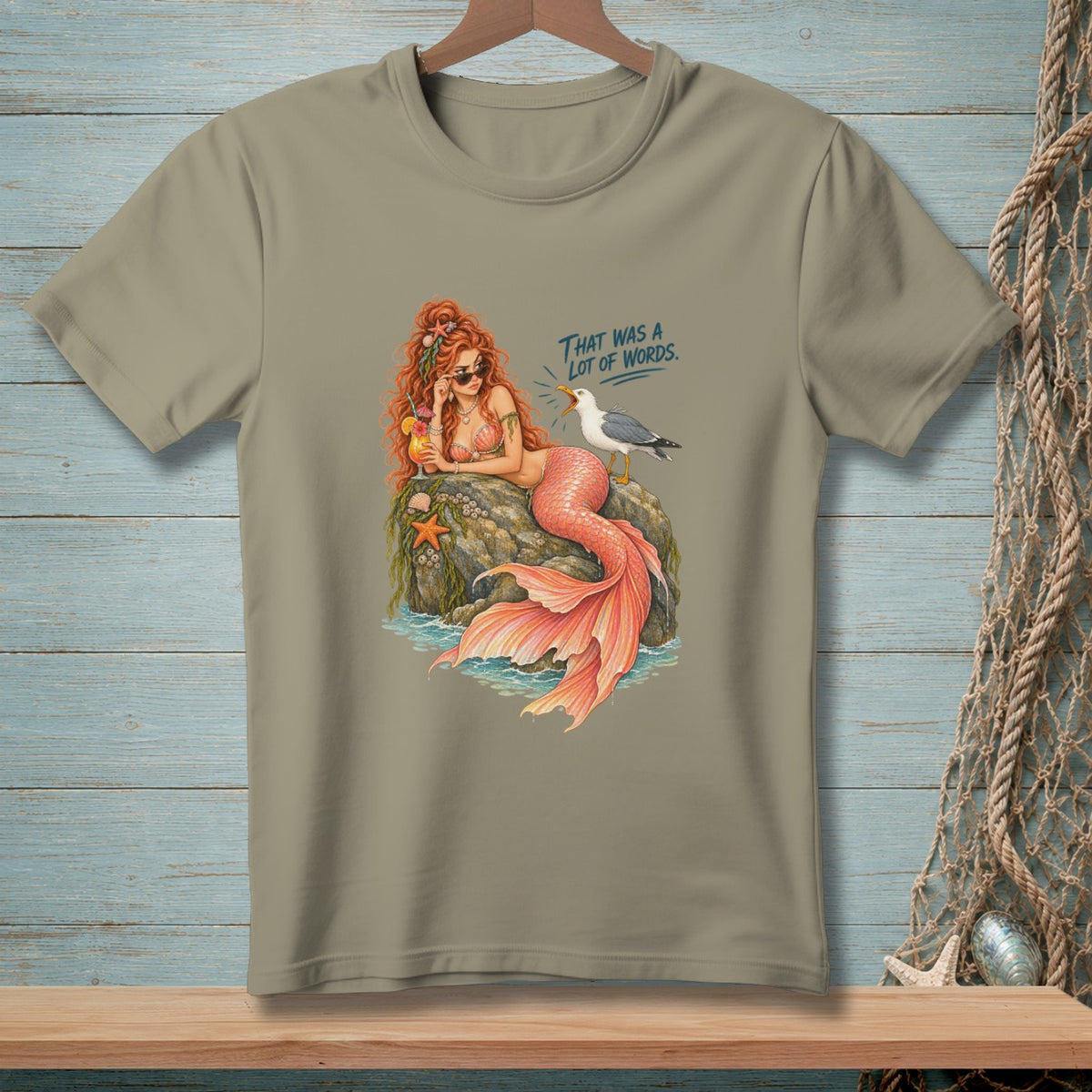 Mermaid with cocktail and sunglasses on a rock, a seagull nearby says "That was a lot of words."