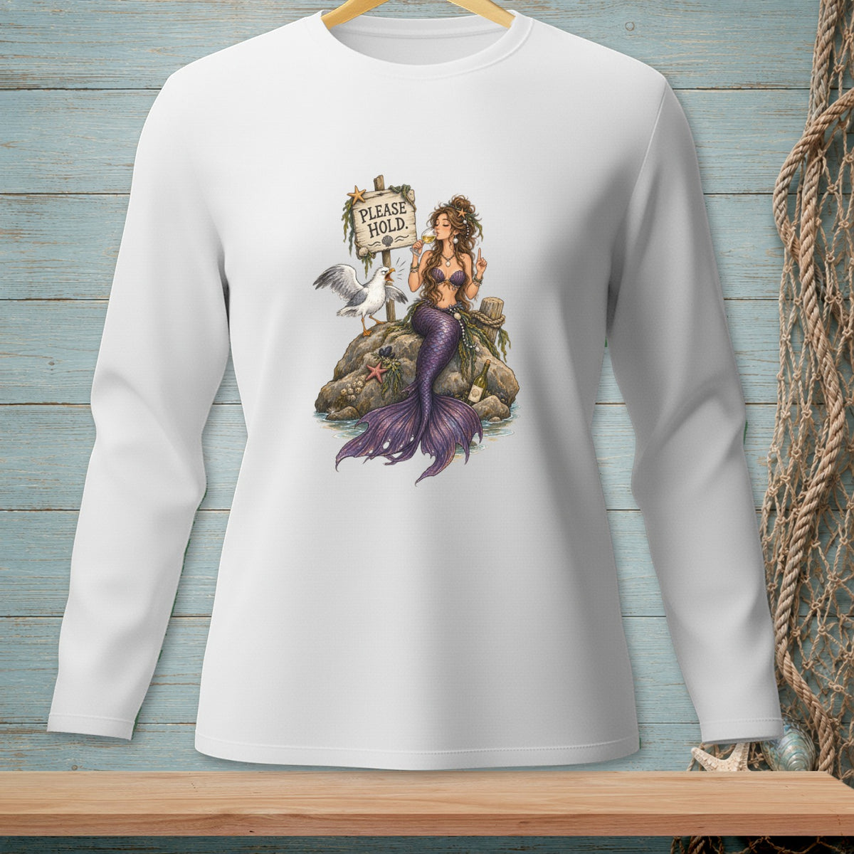 White long-sleeve shirt with mermaid illustration and "PLEASE HOLD." text.