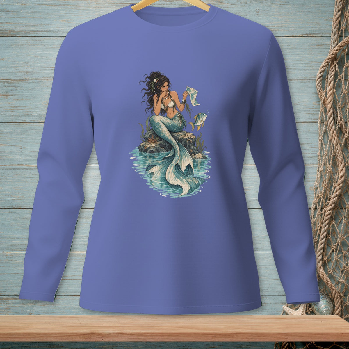 Long sleeve shirt with a purple design of a mermaid sitting on a rock with a map.