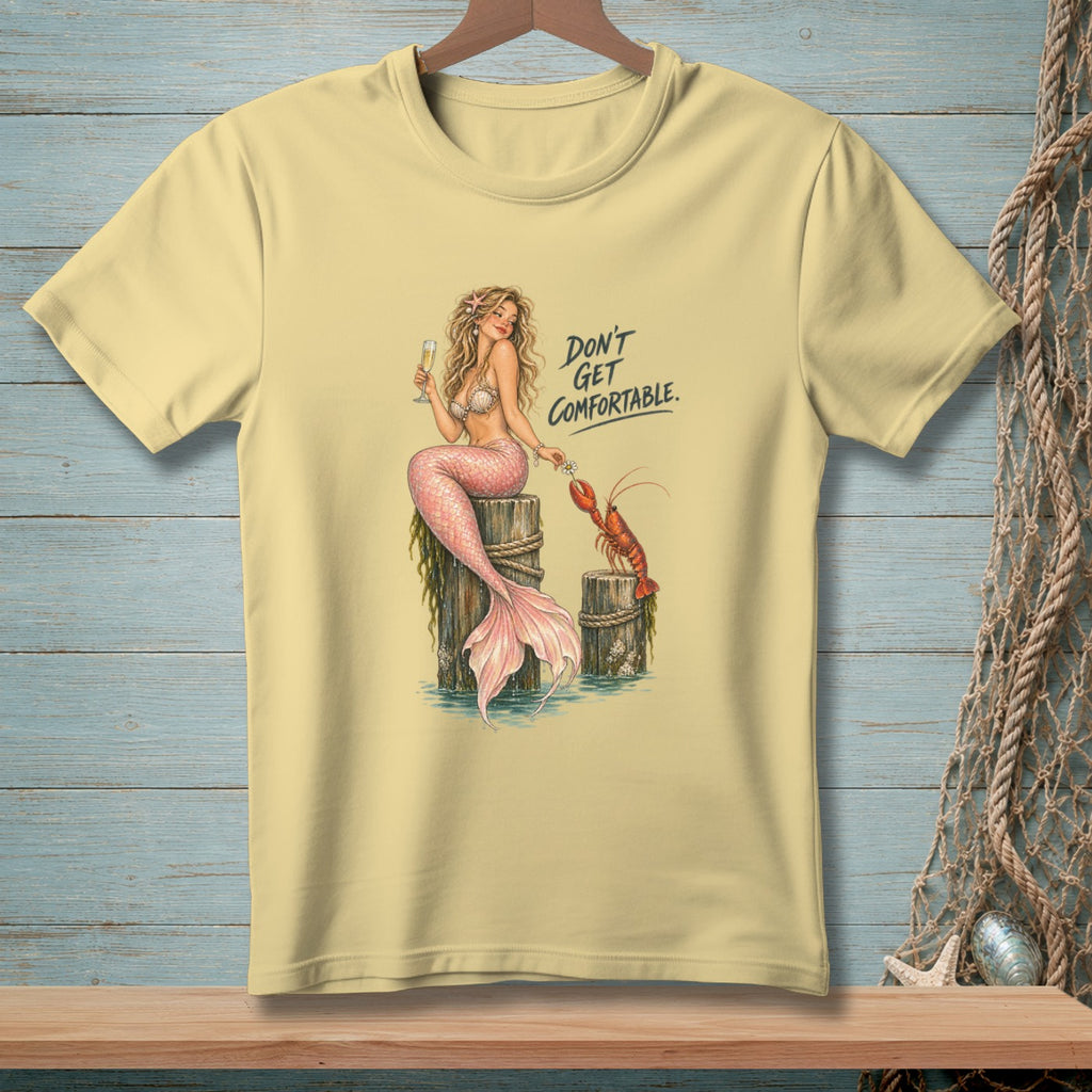 Yellow t-shirt with illustration of a mermaid and lobster with text "Don't Get Comfortable."