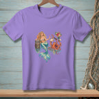 Mermaid and octopus enjoying a drink and flowers on a light purple t-shirt.