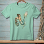 Mermaid leaning on dock near "Proper Footwear Required" sign.