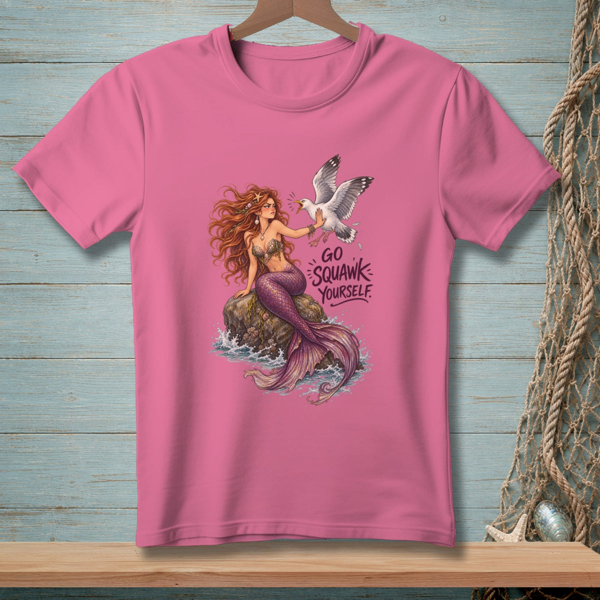 Pink t-shirt with mermaid and seagull graphic reading "GO SQUAWK YOURSELF".