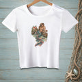 White t-shirt with vintage-style mermaid illustration on a rocky shore.