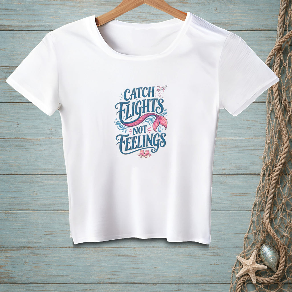 White t-shirt with "Catch Flights Not Feelings" and a mermaid tail design.