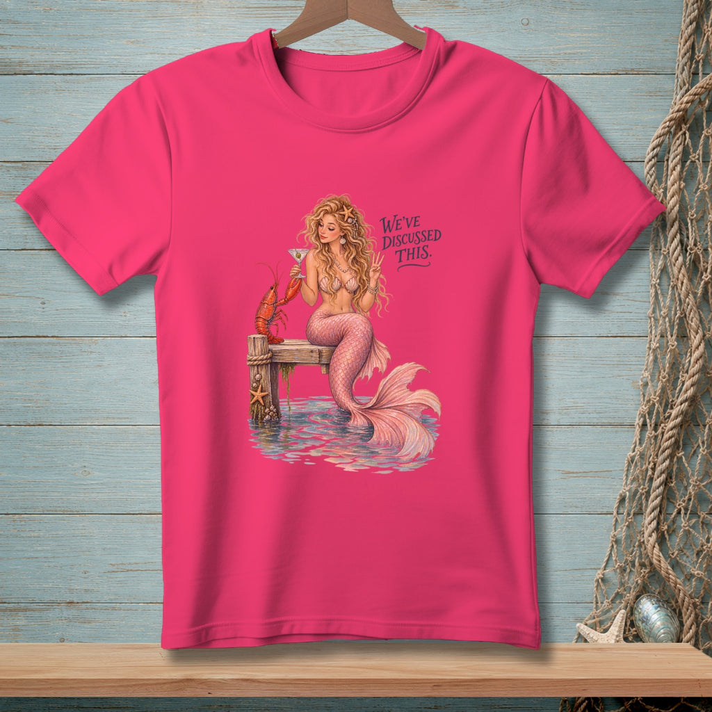 Pink t-shirt with a mermaid, lobster, martini, and text "We've discussed this".