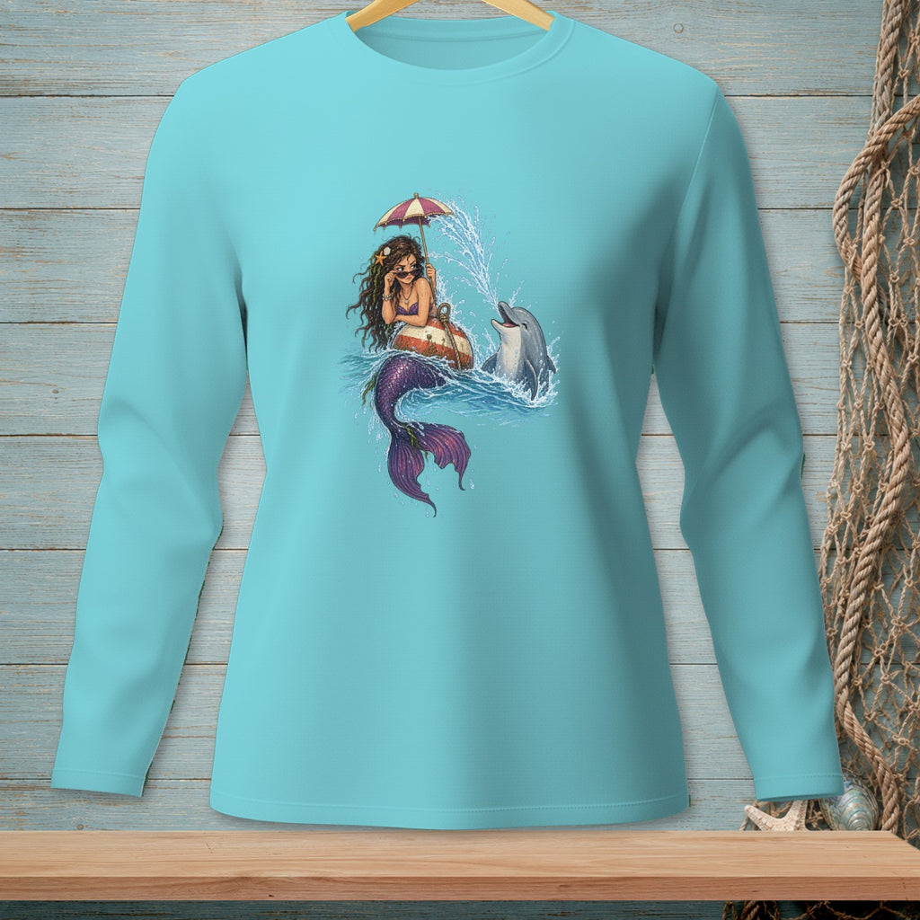 Mermaid under an umbrella with a dolphin splashing water, on a blue shirt.
