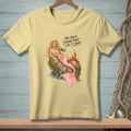 Yellow t-shirt with mermaid pouring champagne, text "You keep saying that like it's bad".