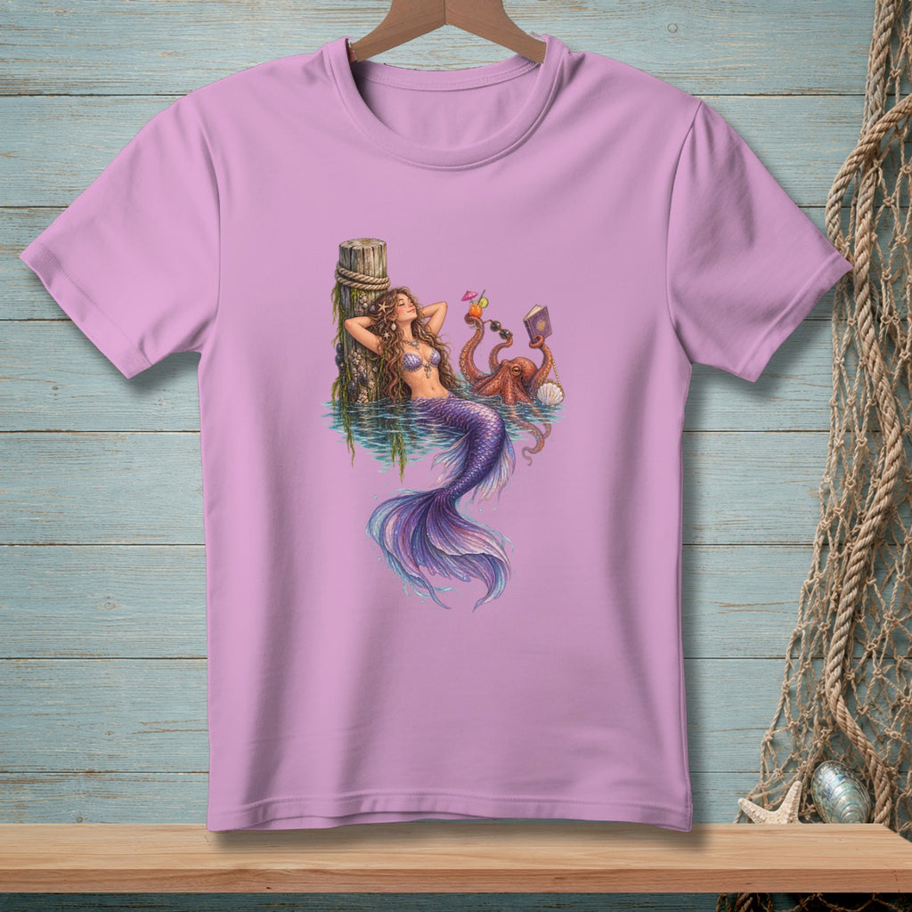 Purple t-shirt with a mermaid, octopus, drinks, and a book in the water.
