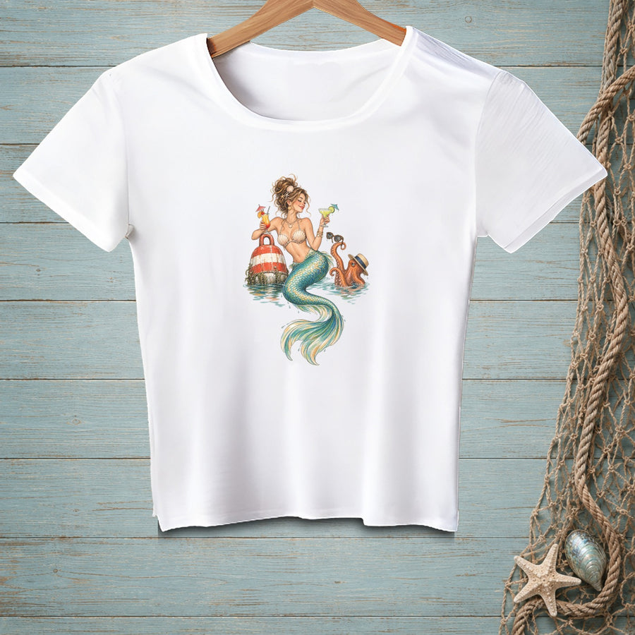 White t-shirt with illustration of a mermaid, octopus, and buoy drinking cocktails.