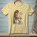 Mermaid sitting on pier brushing a crab with text "SAVE YOURSELF."