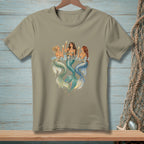 Three mermaids in water raise champagne glasses, their tails shimmering.