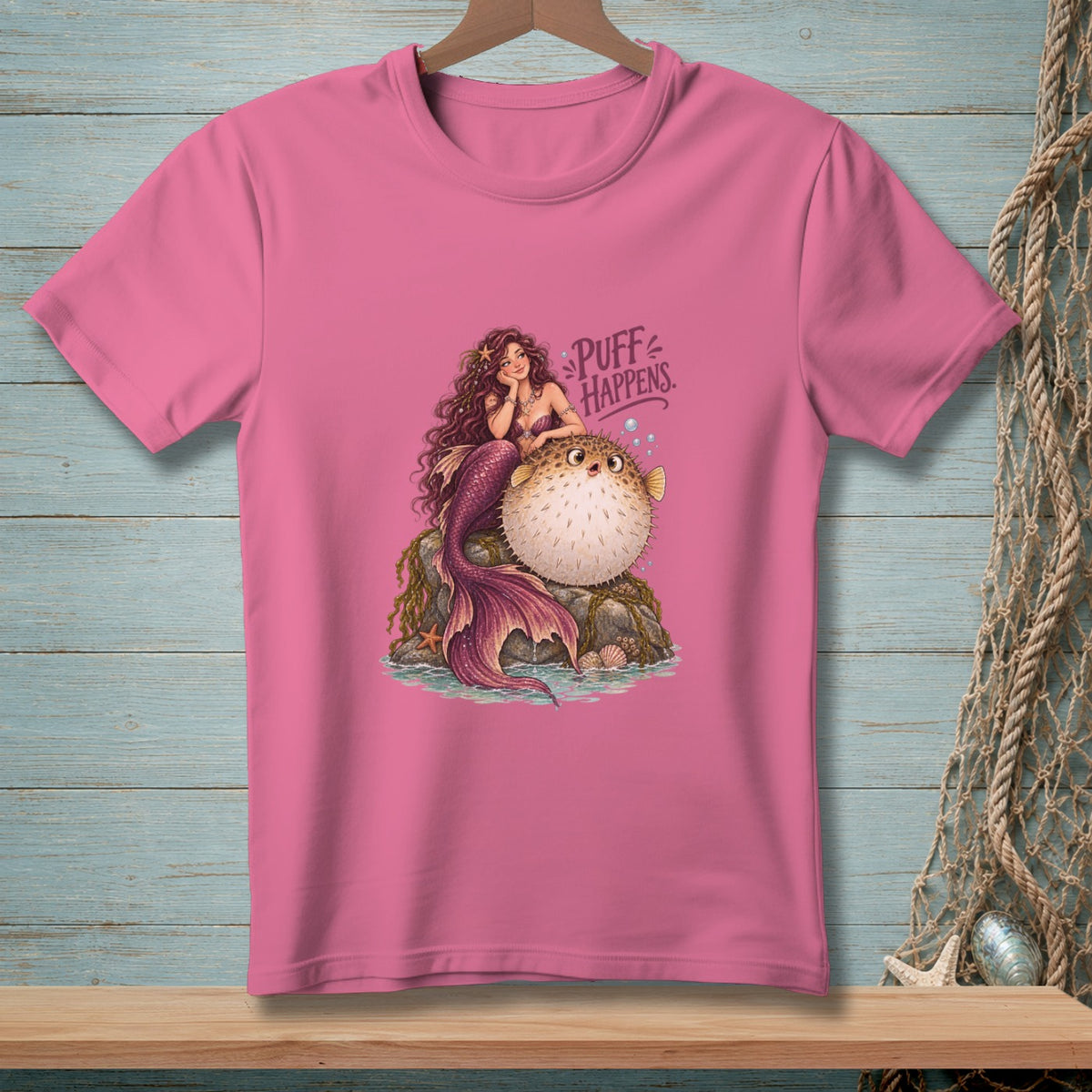 Pink t-shirt featuring a mermaid and pufferfish with "Puff Happens" text.