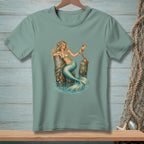 Mermaid with drink and crab on a pier, printed on a green t-shirt.