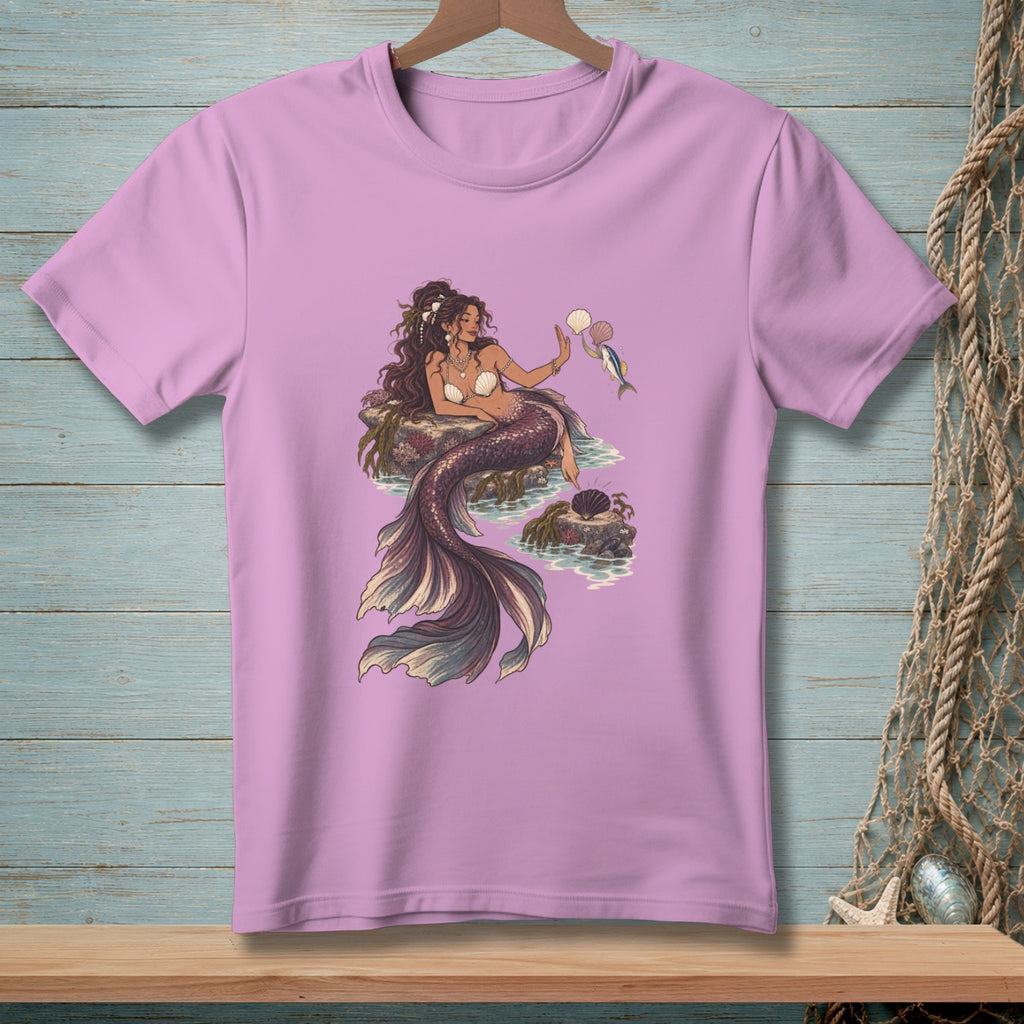 Pink t-shirt featuring a mermaid holding shells and a fish.