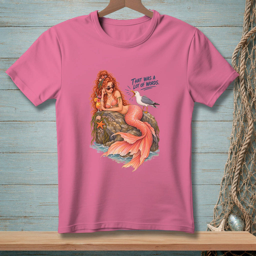 Pink t-shirt with a mermaid on a rock and a seagull with text "That was a lot of words."
