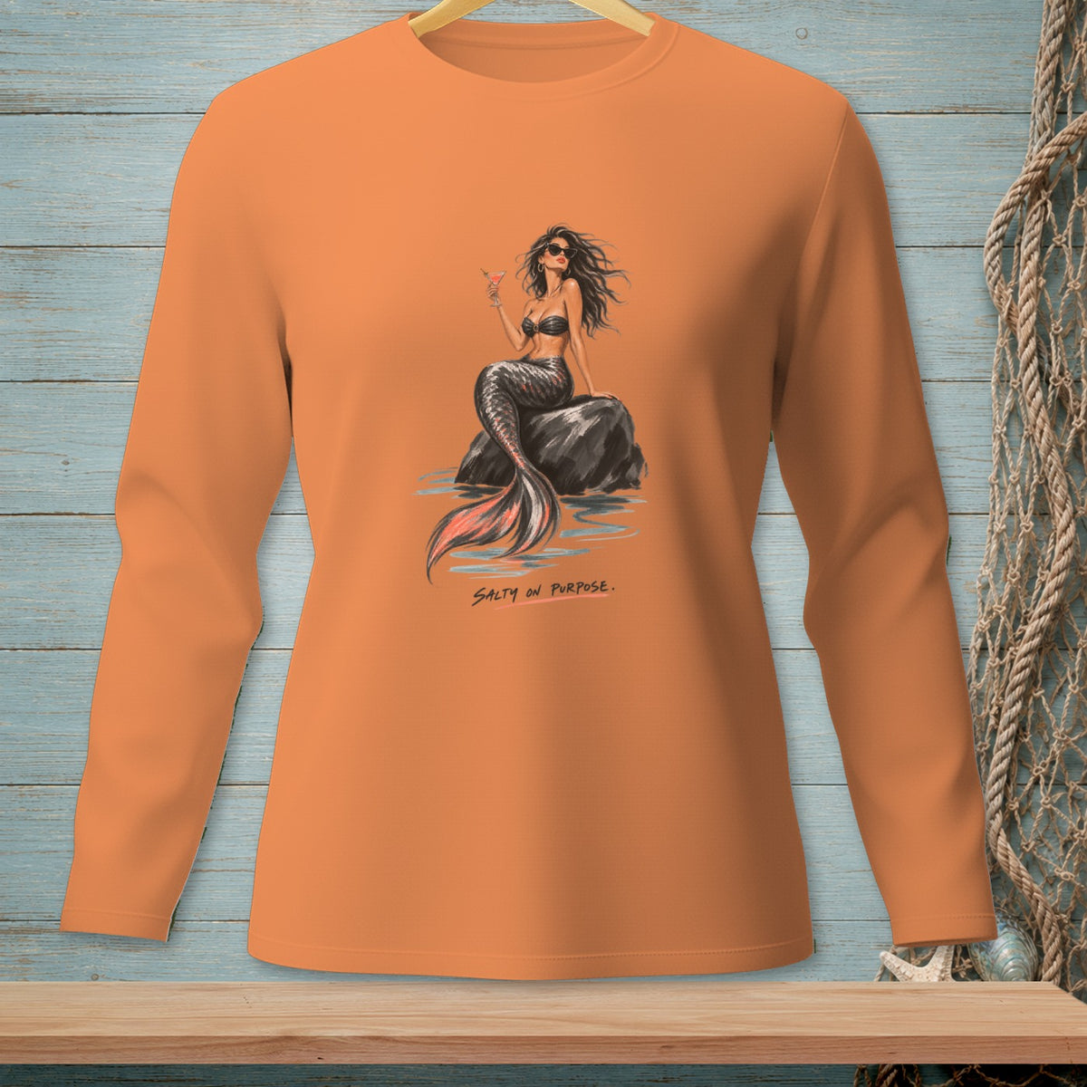 Orange long-sleeve shirt with a mermaid graphic and text "SALTY ON PURPOSE."