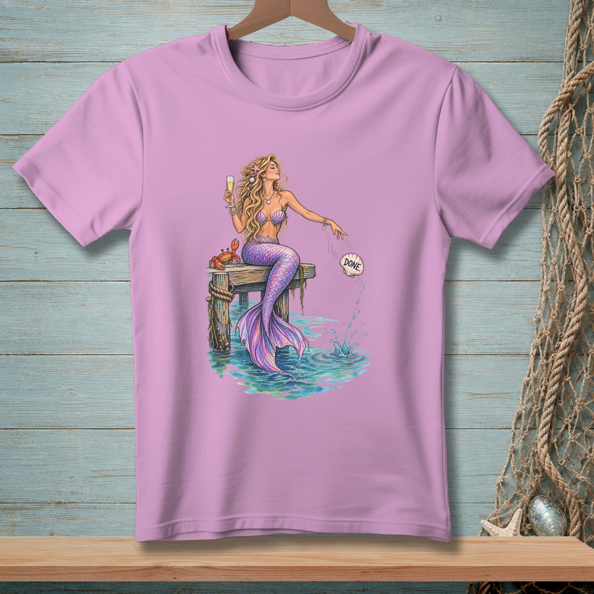 Mermaid on dock with glass of champagne, crab, and a shell labeled "DONE".