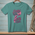 Teal t-shirt with pink mermaid tail graphic and text that reads "Sassy by Nature Salty by Choice."