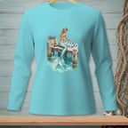 Mermaid sitting on a wooden dock with a striped towel and woven basket.