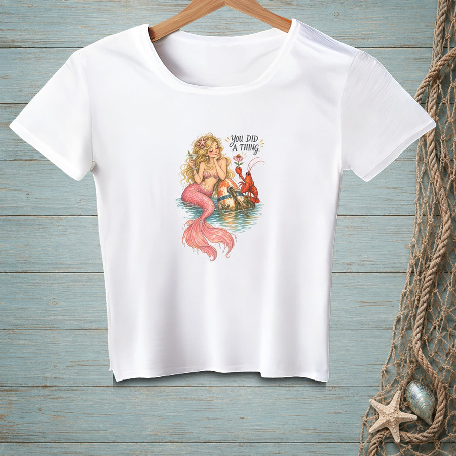 White t-shirt with a mermaid, lobster, and text "YOU DID A THING."