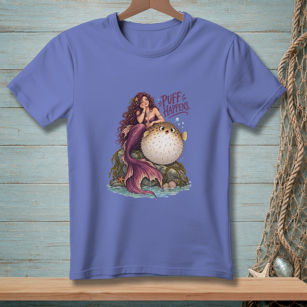 Mermaid and pufferfish illustration with text "Puff Happens" on purple t-shirt.