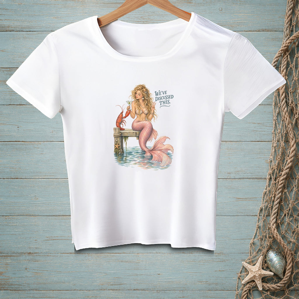 White t-shirt with mermaid, lobster, cocktail, and text "WE'VE DISCUSSED THIS."