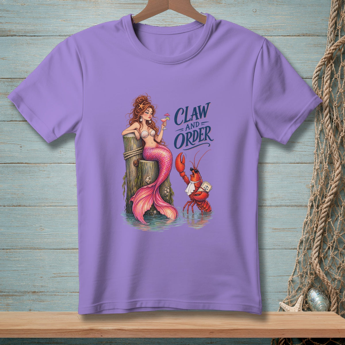 A mermaid and a lobster with text "Claw And Order" on a purple t-shirt.