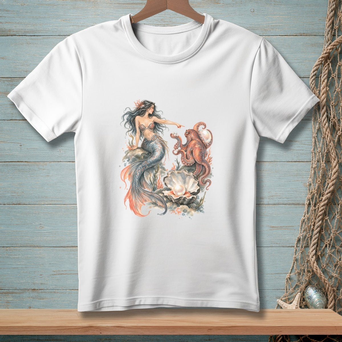 White t-shirt featuring a mermaid interacting with an octopus near a large pearl.