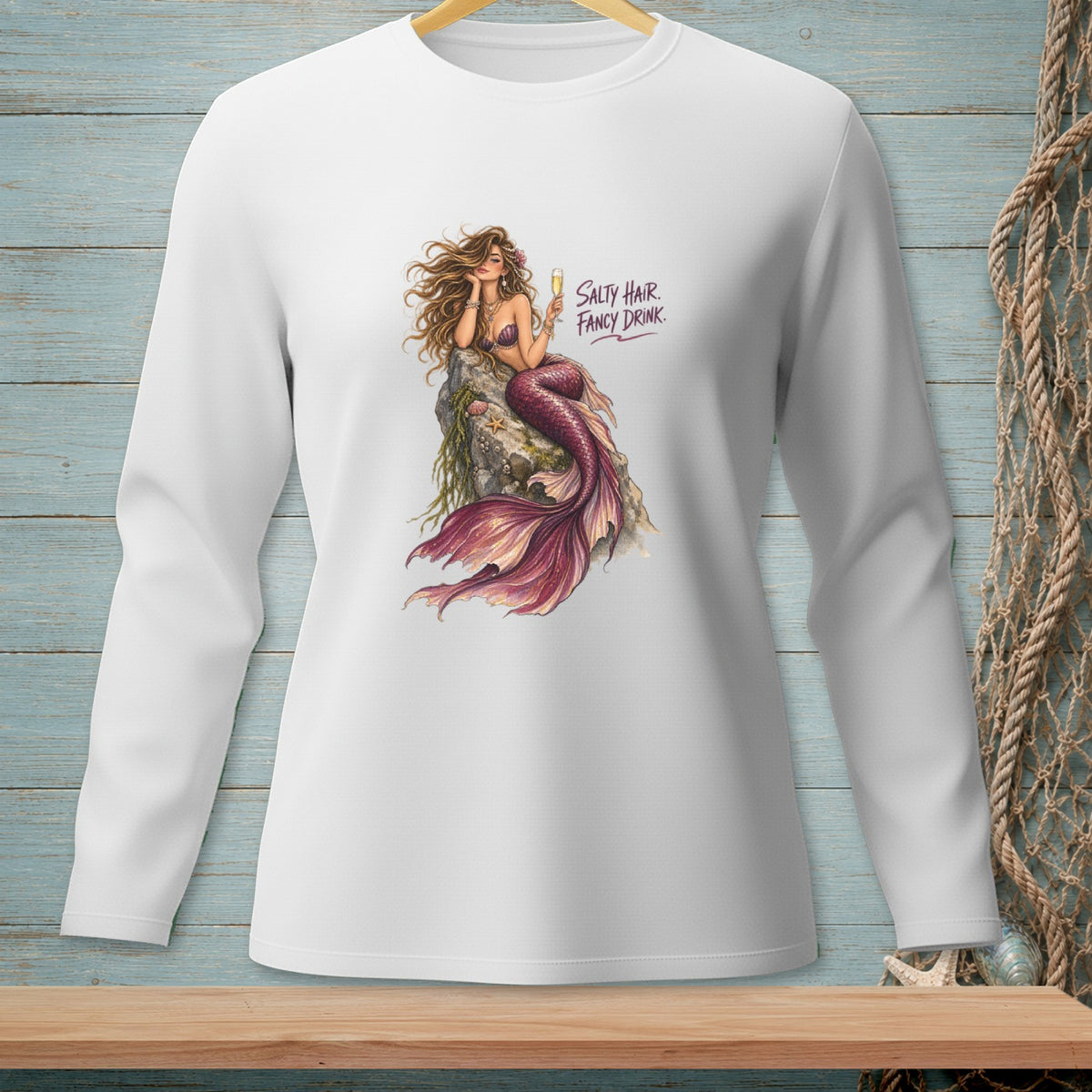 Long sleeve white shirt with mermaid graphic and text "Salty Hair Fancy Drink."