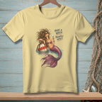 Yellow t-shirt with a mermaid design and text "HAIR'S A WRECK. PRIORITIES INTACT."