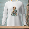 Long-sleeve white shirt with a mermaid graphic sitting on a rock.