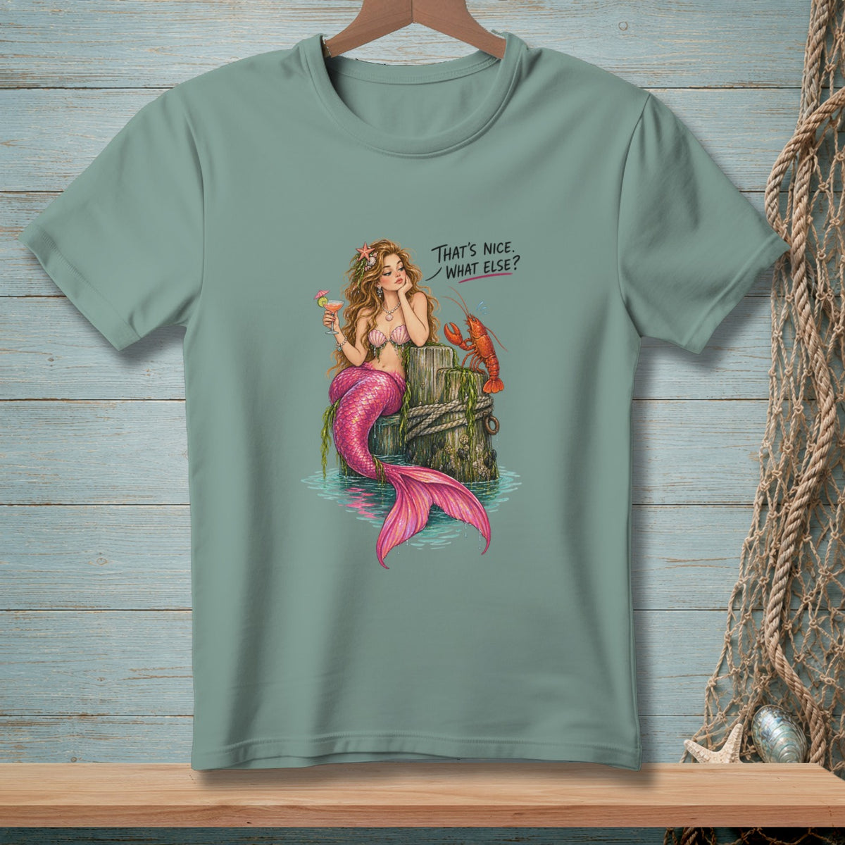 Mermaid with lobster and drink, with text "That's Nice. What Else?"