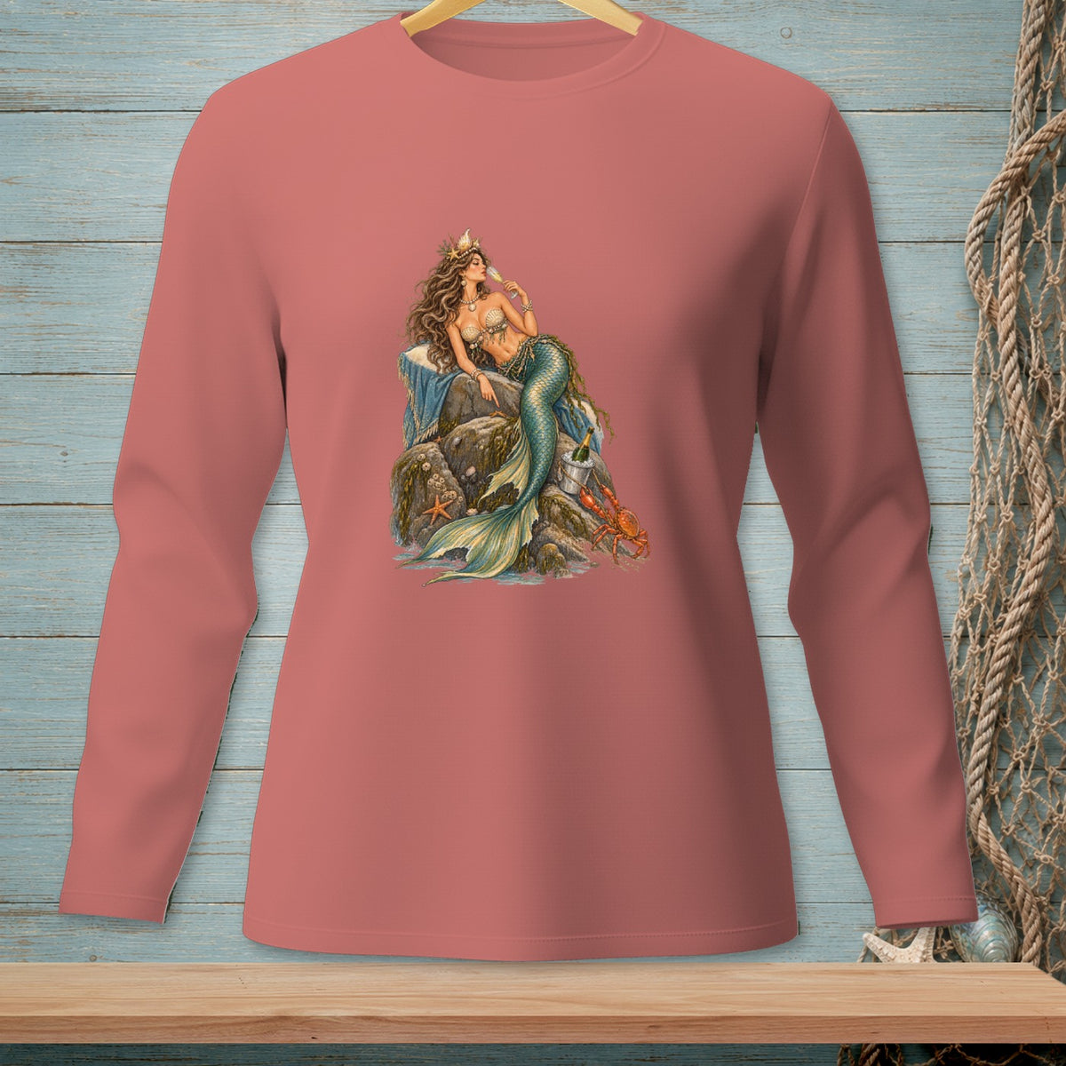 Long-sleeved shirt with a mermaid drinking champagne on a rock.