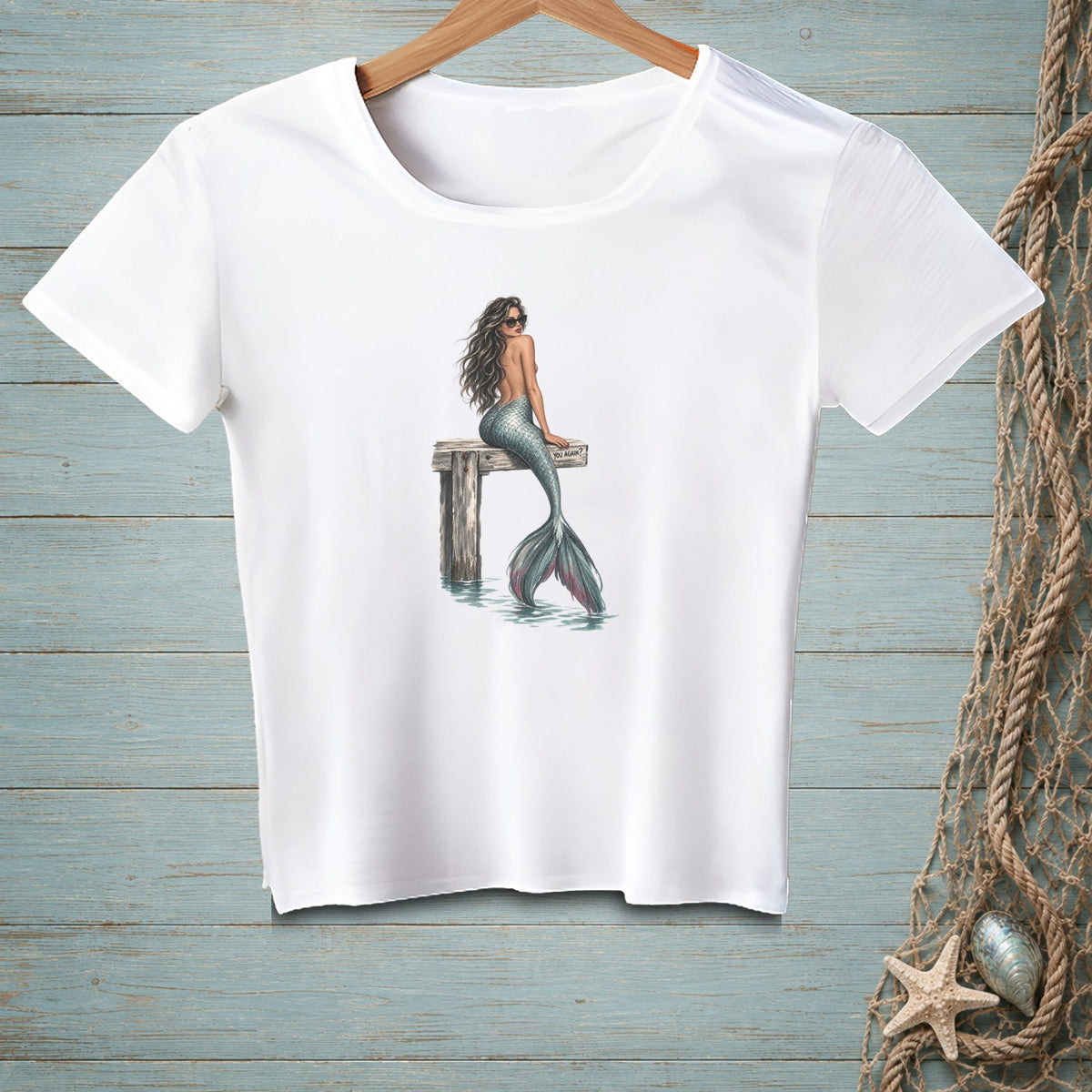 White t-shirt with a mermaid illustration sitting on a dock, "YOU AGAIN?" sign.