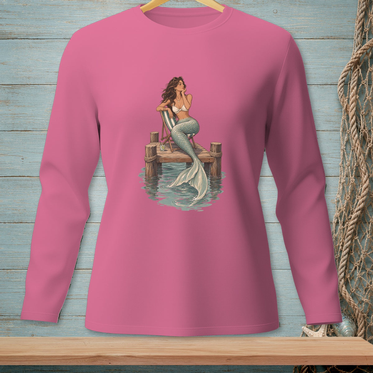 Mermaid on a pier with a drink, detailed illustration on a pink long-sleeve shirt.