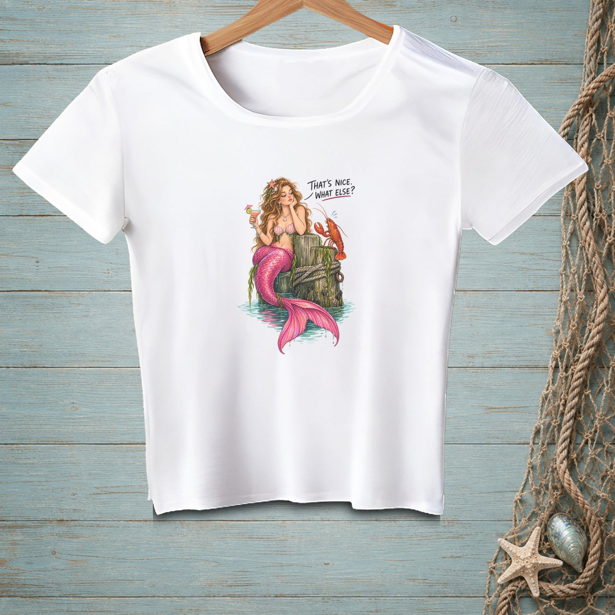 White t-shirt with illustration of a mermaid and lobster saying "That's nice. What else?".