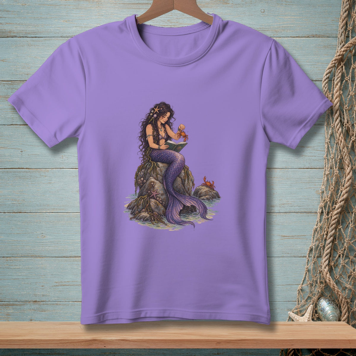 Mermaid reading book on rock with crabs and starfish in water.