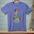 Mermaid sitting on a dock with a striped chair in the water.