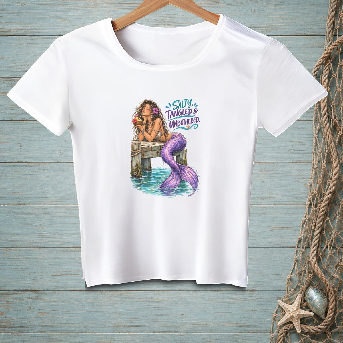 White t-shirt with mermaid and text "SALTY, TANGLED & UNBOTHERED" graphic.