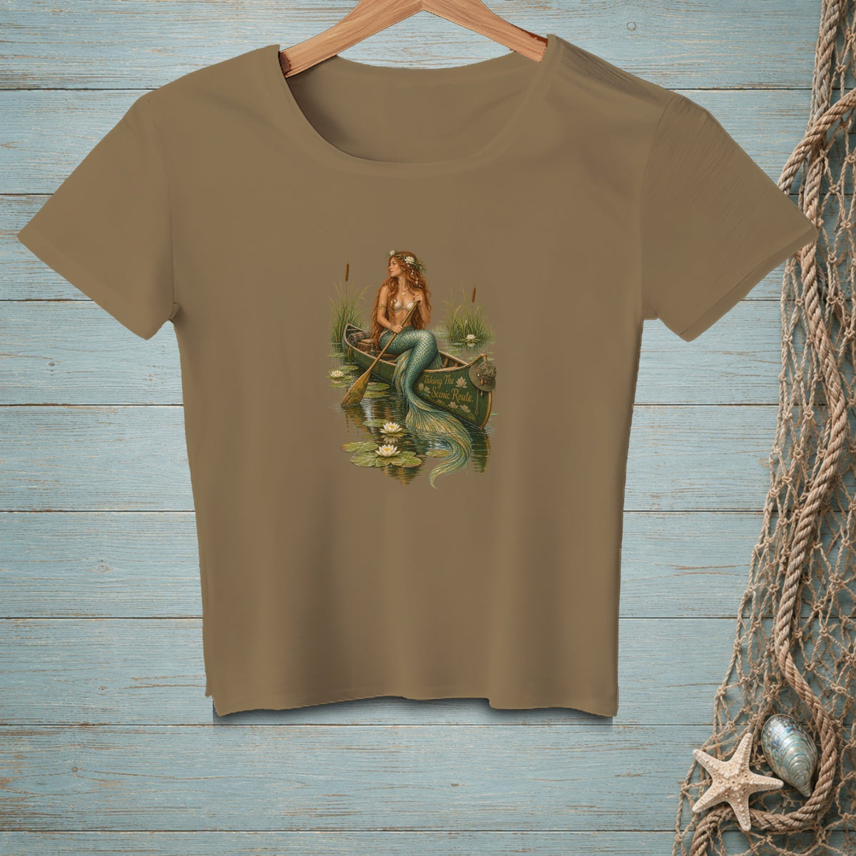 Mermaid in a canoe with lily pads, text reads "Taking The Scenic Route".