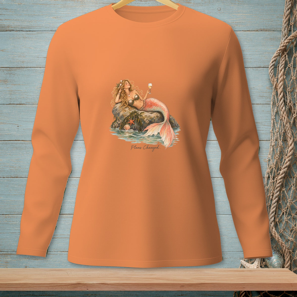 Orange long-sleeve shirt with mermaid graphic and "Plans Changed" text.